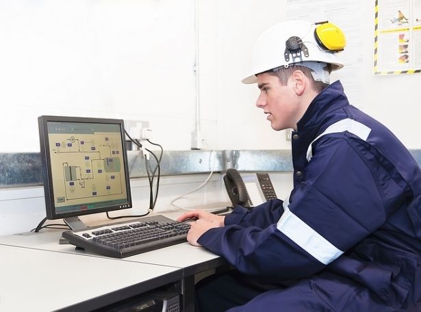 An industry worker sitting in front of a PC