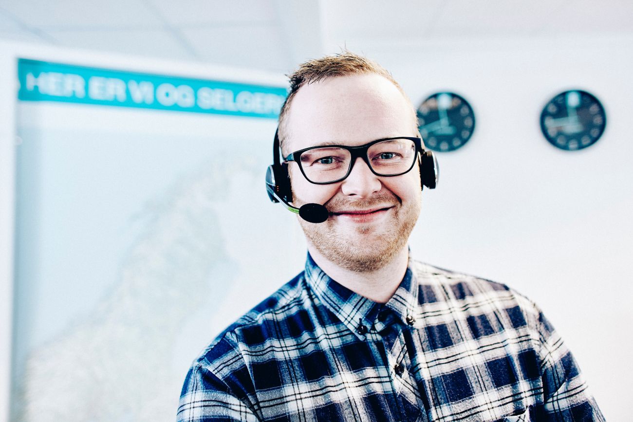 Male customer service agent wearing a headset in the ABAX office 