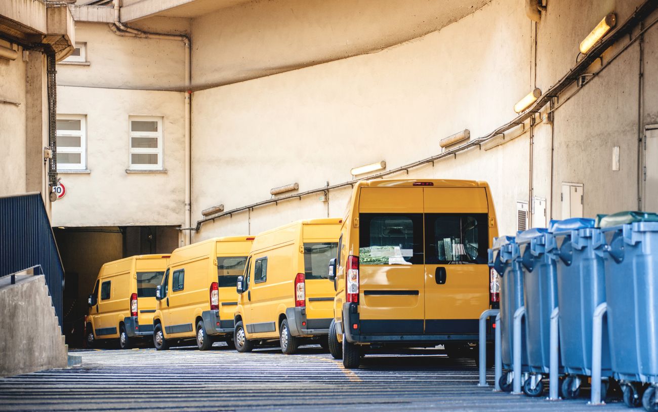 Żółte samochody służbowe zaparkowane przed budynkiem