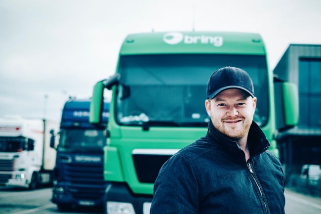 Man standing in front of a green truck