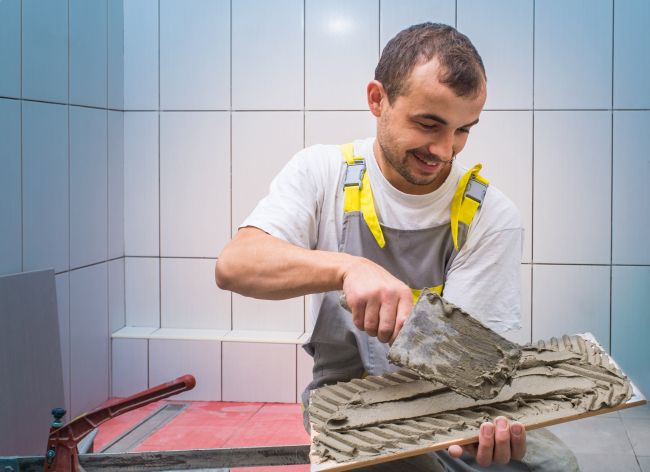 Worker with tiles